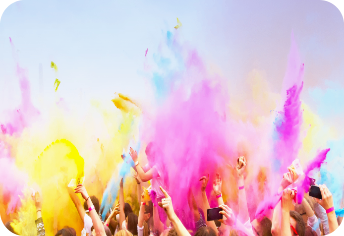 People celebrating with colorful powder in air.