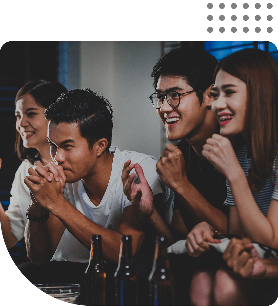 Friends watching sports game, cheering enthusiastically together.
